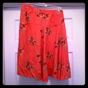 Peach/pink skirt above knee with flowers